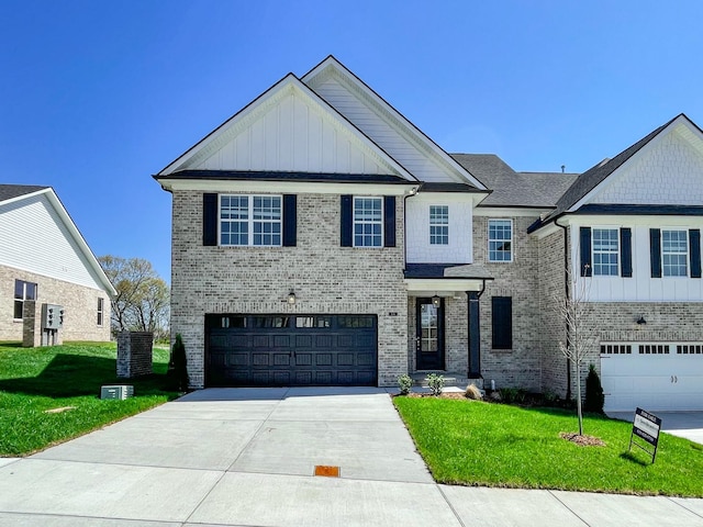 136 Lightberry Ln, Hendersonville, TN 37075 - view of front of property featuring board and batten siding, concrete driveway, an attached garage, and a front yard