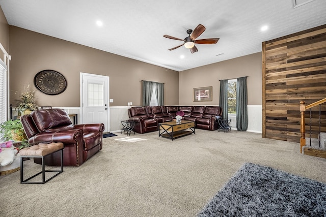 carpeted living area with ceiling fan, wainscoting, and recessed lighting