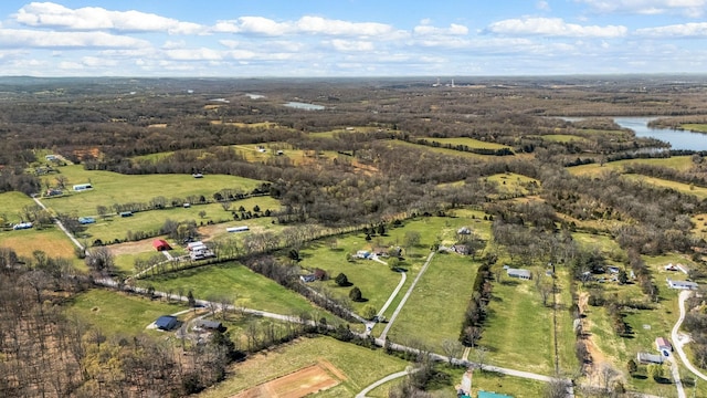 aerial view of property and surrounding area featuring rural landscape and a large body of water