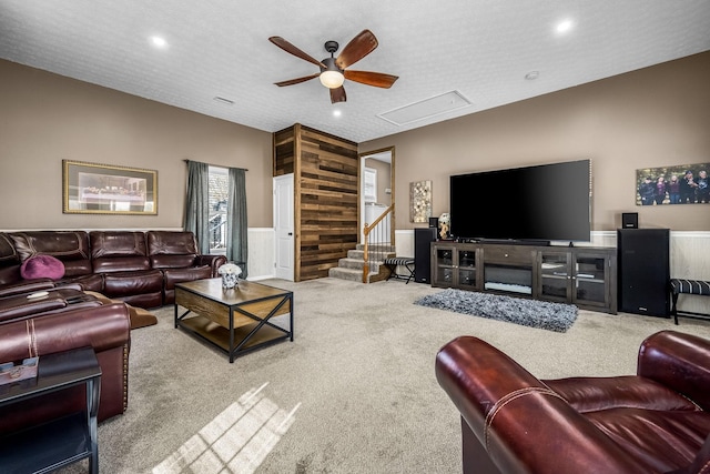 living room featuring a ceiling fan, carpet floors, stairway, recessed lighting, and wainscoting