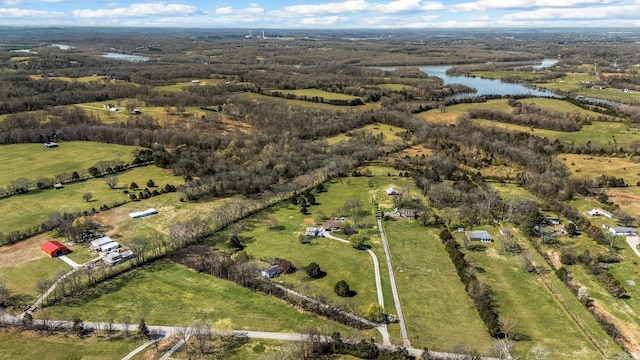 aerial view of property and surrounding area featuring a nearby body of water and rural landscape