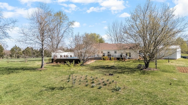 view of grassy yard featuring a deck
