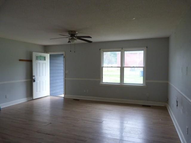 114 Bruce St, Huntland, TN 37345 - empty room featuring wood finished floors, ceiling fan, and baseboards