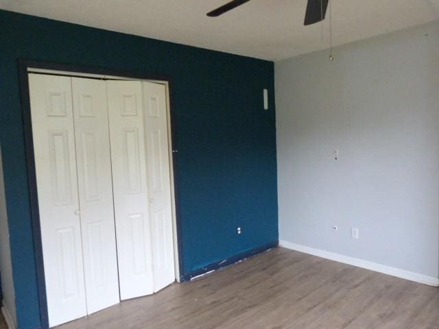 114 Bruce St, Huntland, TN 37345 - unfurnished bedroom with wood finished floors, a closet, baseboards, and ceiling fan