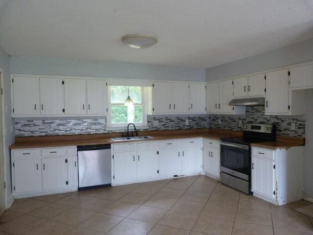 114 Bruce St, Huntland, TN 37345 - kitchen featuring appliances with stainless steel finishes, under cabinet range hood, a sink, backsplash, and white cabinets