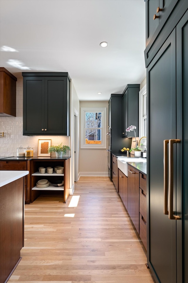 1908 Beechwood Ave, Nashville, TN 37212 - kitchen featuring light wood-type flooring, decorative backsplash, baseboards, recessed lighting, and dishwashing machine