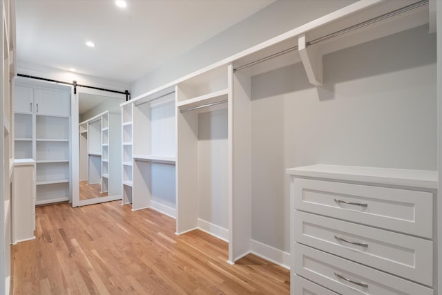 1908 Beechwood Ave, Nashville, TN 37212 - walk in closet with light wood-style flooring and a barn door