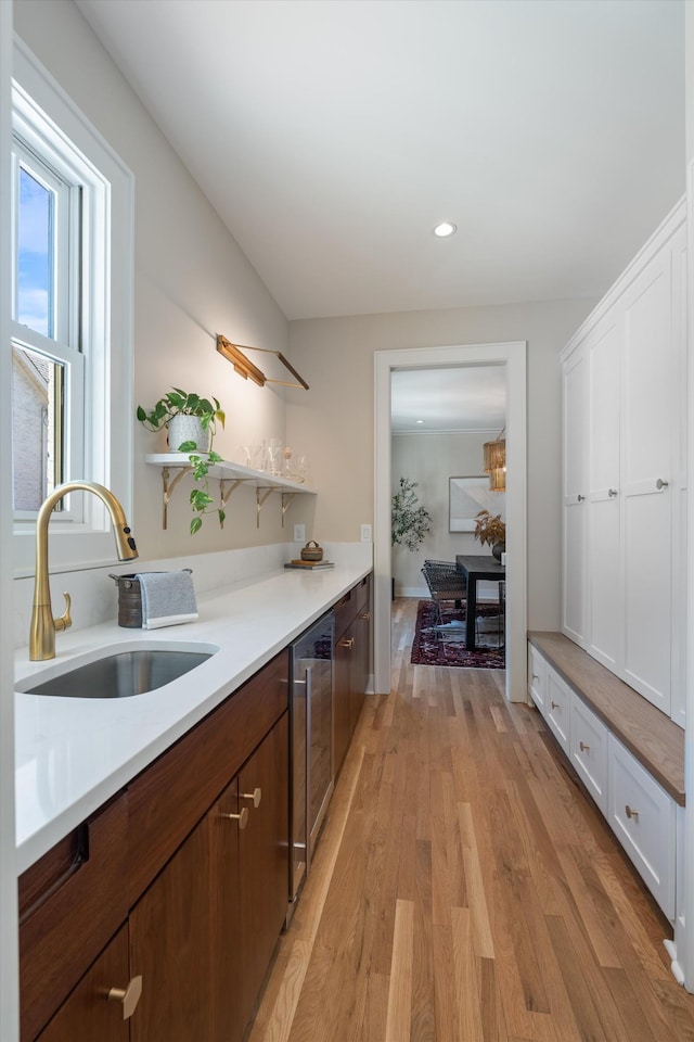 1908 Beechwood Ave, Nashville, TN 37212 - kitchen with a sink, wine cooler, light countertops, light wood finished floors, and open shelves
