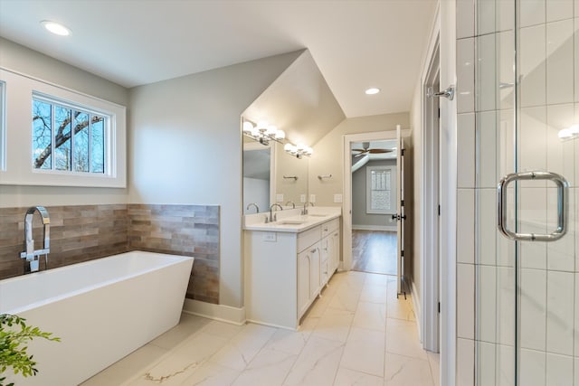 1908 Beechwood Ave, Nashville, TN 37212 - bathroom with marble look tiles, a soaking tub, double vanity, a stall shower, and recessed lighting