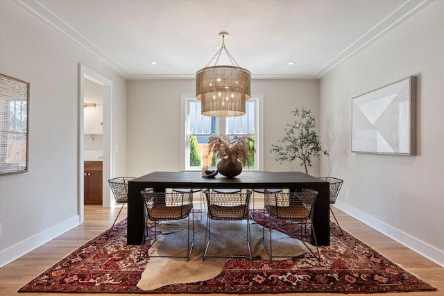 1908 Beechwood Ave, Nashville, TN 37212 - dining area featuring crown molding, light wood-style flooring, a chandelier, and baseboards