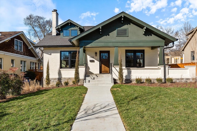 1908 Beechwood Ave, Nashville, TN 37212 - view of front of house featuring a chimney, brick siding, covered porch, and a shingled roof