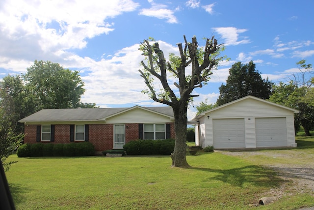 ranch-style house featuring an outbuilding, brick siding, a front lawn, and a garage