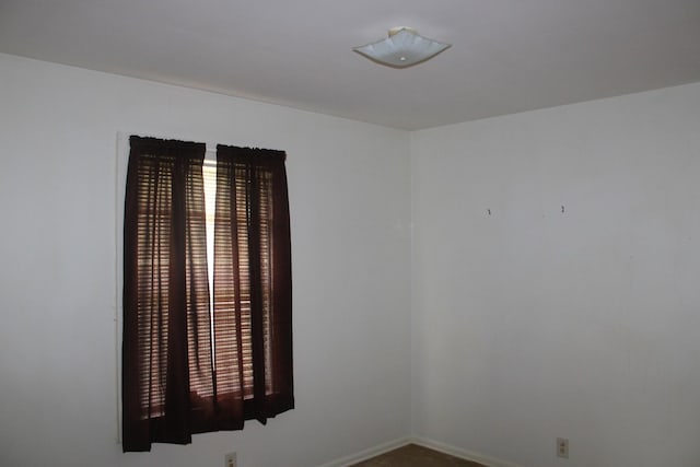 spare room featuring baseboards