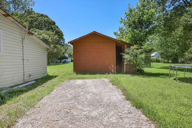 506 Daugherty St, La Fayette, GA 30728 - view of side of property featuring a trampoline, a lawn, and an outbuilding