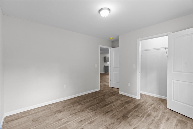 674 Eber Rd, Dalton, GA 30720 - unfurnished bedroom with wood finished floors, baseboards, and a closet