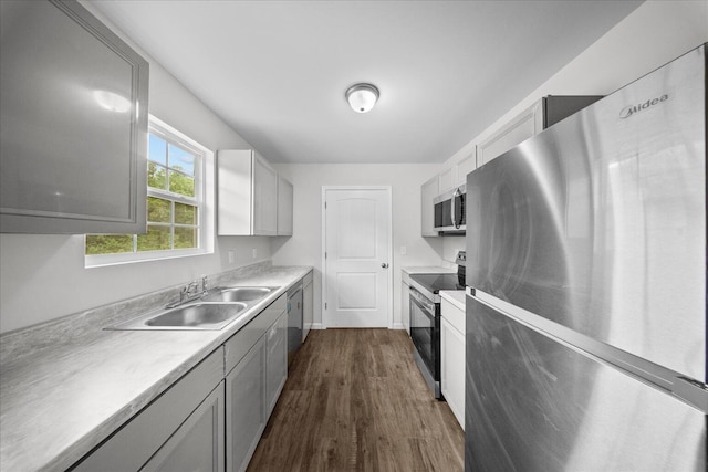 674 Eber Rd, Dalton, GA 30720 - kitchen with stainless steel appliances, a sink, dark wood-style floors, and light countertops