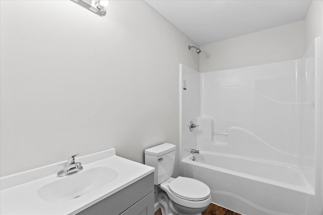 674 Eber Rd, Dalton, GA 30720 - bathroom featuring toilet, vanity, shower / bathtub combination, and wood finished floors