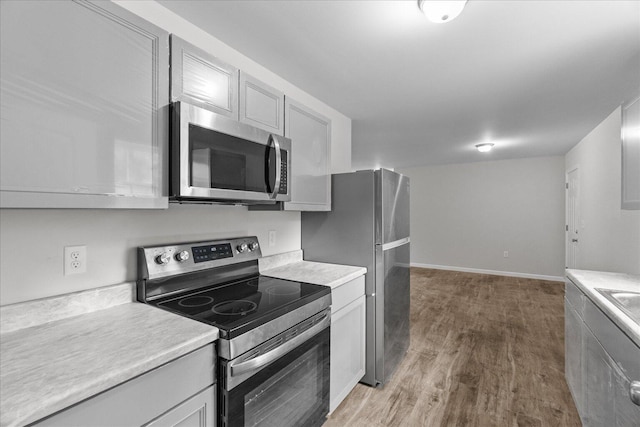 674 Eber Rd, Dalton, GA 30720 - kitchen with stainless steel appliances, light countertops, and light wood-style floors