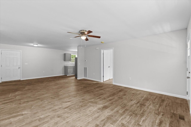674 Eber Rd, Dalton, GA 30720 - unfurnished living room with ceiling fan, wood finished floors, and baseboards
