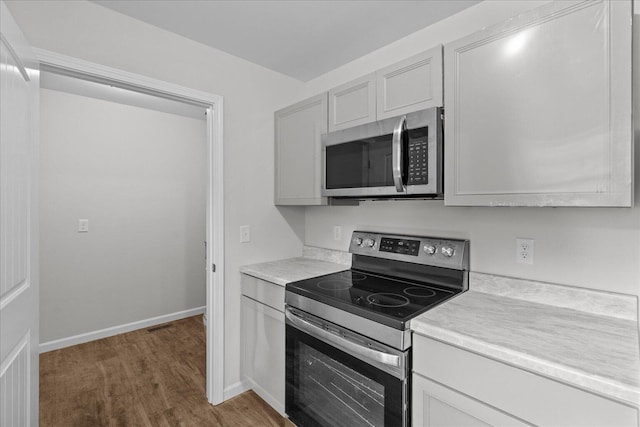 674 Eber Rd, Dalton, GA 30720 - kitchen featuring appliances with stainless steel finishes, light countertops, wood finished floors, and baseboards