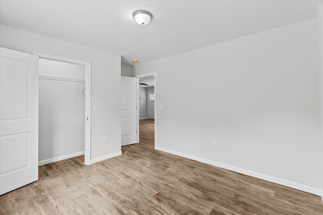 674 Eber Rd, Dalton, GA 30720 - unfurnished bedroom with wood finished floors, baseboards, and a closet