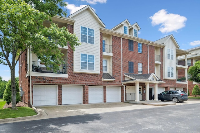 3201 Aspen Grove Dr Unit F4, Franklin, TN 37067 - view of property with an attached garage, brick siding, and driveway