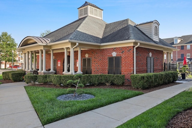 3201 Aspen Grove Dr Unit F4, Franklin, TN 37067 - exterior space featuring brick siding, roof with shingles, covered porch, and a lawn