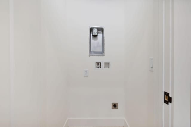 clothes washing area with hookup for an electric dryer, baseboards, and hookup for a washing machine