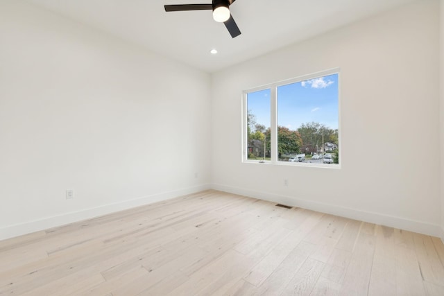 empty room with baseboards, a ceiling fan, light wood-style flooring, and recessed lighting