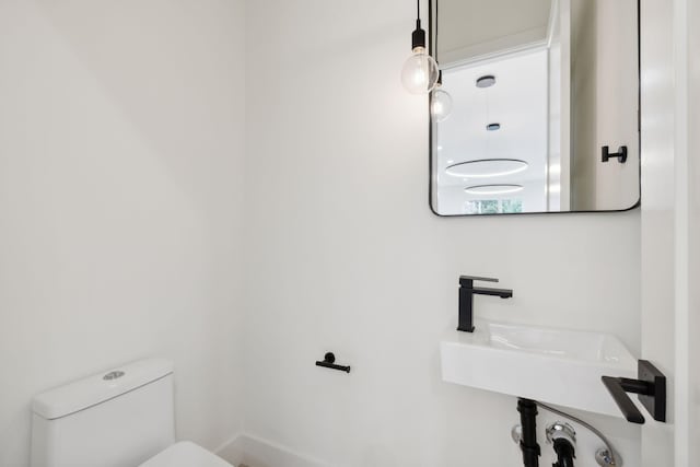 bathroom featuring toilet and a sink