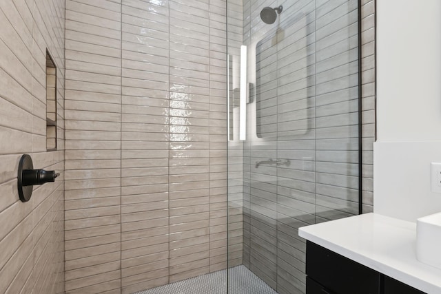 bathroom with a stall shower and vanity