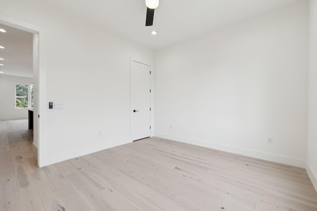 spare room with recessed lighting, light wood finished floors, ceiling fan, and baseboards