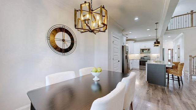 788 Jersey Dr, Clarksville, TN 37043 - dining space with crown molding, light wood finished floors, a chandelier, and recessed lighting