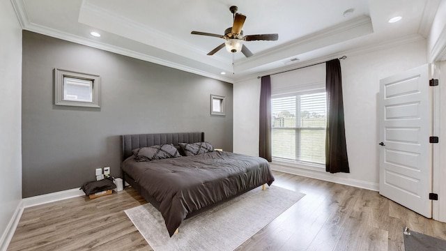 788 Jersey Dr, Clarksville, TN 37043 - bedroom with a tray ceiling, light wood-style floors, crown molding, baseboards, and a ceiling fan