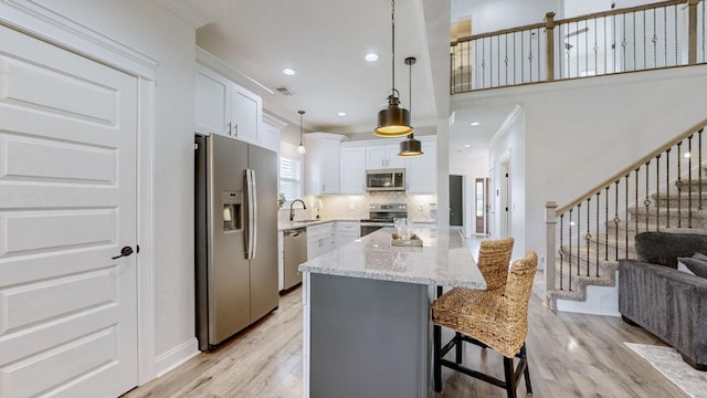 788 Jersey Dr, Clarksville, TN 37043 - kitchen with stainless steel appliances, ornamental molding, light wood-style floors, a sink, and tasteful backsplash