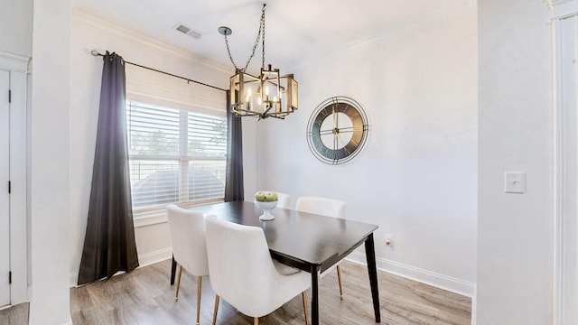 788 Jersey Dr, Clarksville, TN 37043 - dining room with a chandelier, light wood finished floors, baseboards, and ornamental molding