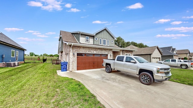 788 Jersey Dr, Clarksville, TN 37043 - view of side of home featuring driveway, board and batten siding, central AC, brick siding, and a garage