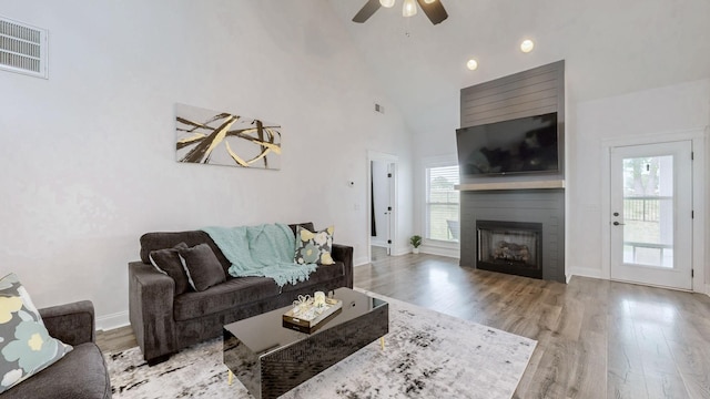788 Jersey Dr, Clarksville, TN 37043 - living area featuring wood finished floors, a ceiling fan, a fireplace, baseboards, and high vaulted ceiling