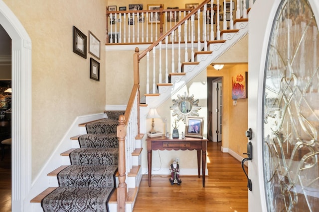 1001 Williams Way, Old Hickory, TN 37138 - staircase with wood finished floors, a towering ceiling, arched walkways, and baseboards