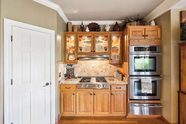 1001 Williams Way, Old Hickory, TN 37138 - kitchen featuring a warming drawer, appliances with stainless steel finishes, under cabinet range hood, tasteful backsplash, and light stone counters