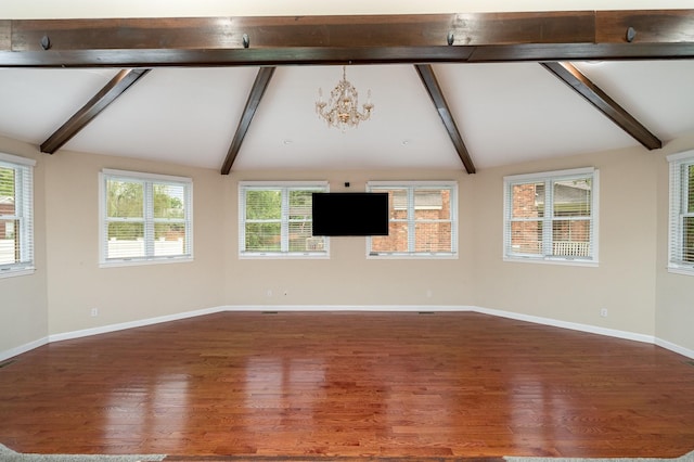 unfurnished room featuring a chandelier, wood finished floors, and baseboards