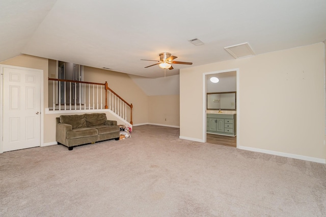 unfurnished living room with lofted ceiling, carpet, ceiling fan, and baseboards