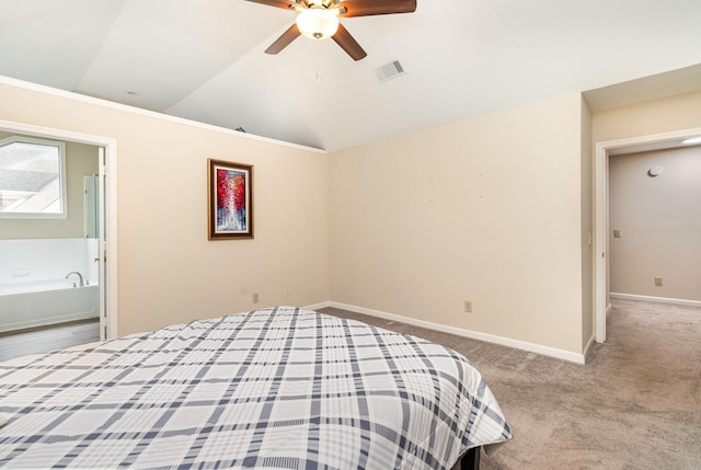 bedroom with vaulted ceiling, baseboards, carpet floors, a ceiling fan, and ensuite bath