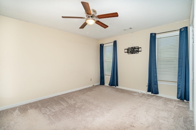 unfurnished room featuring carpet floors, baseboards, a ceiling fan, and plenty of natural light