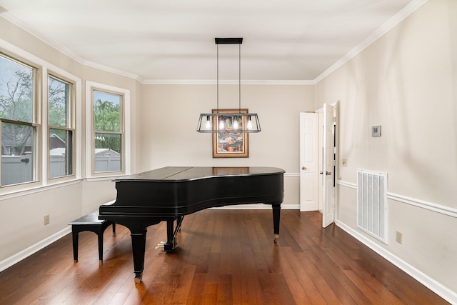 sitting room featuring dark wood-style flooring, crown molding, and baseboards