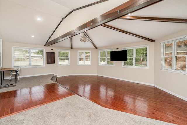 unfurnished living room with wood finished floors, baseboards, and recessed lighting