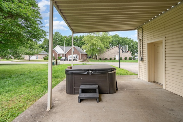 view of patio / terrace featuring a hot tub and a residential view