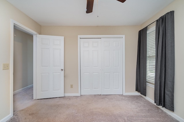 unfurnished bedroom with carpet floors, a closet, and baseboards