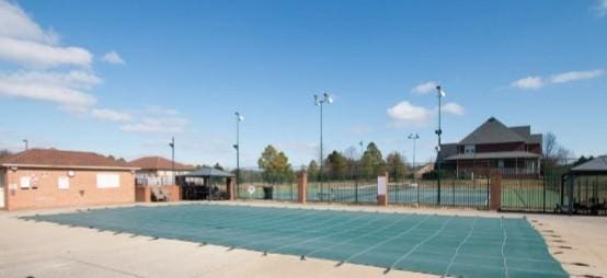 community pool featuring fence and a gazebo