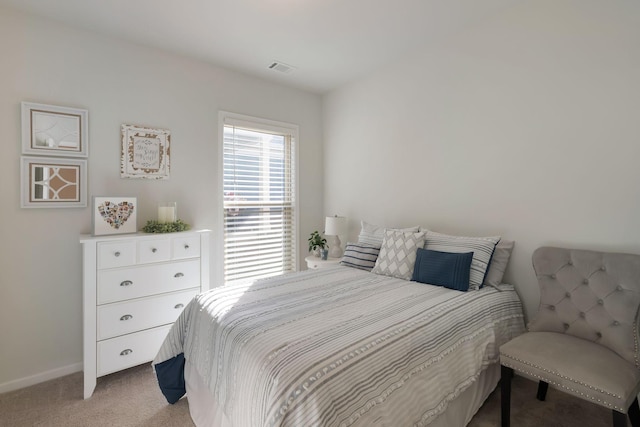 bedroom featuring light carpet and baseboards